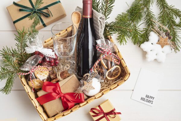 Refined Christmas gift basket for culinary enthusiats with bottle of wine and mulled wine